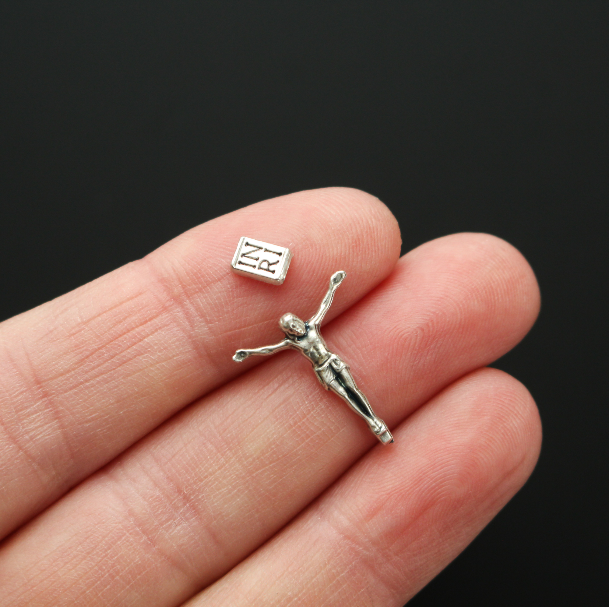 tiny detailed corpus that comes with an INRI sign that can be attached to a cross with a hot glue gun or other adhesive