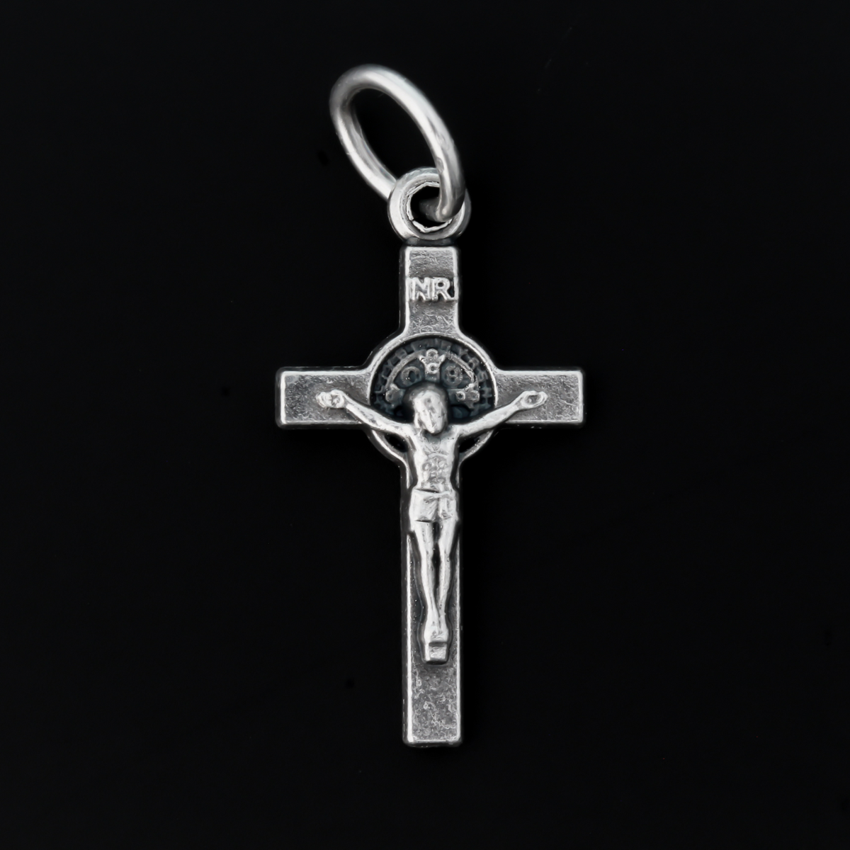 This small but detailed, die-cast (silver oxidized with the finest finish), Saint Benedict medal crucifix is 0.875" (22mm) long and features a St. Benedict medal, front and back