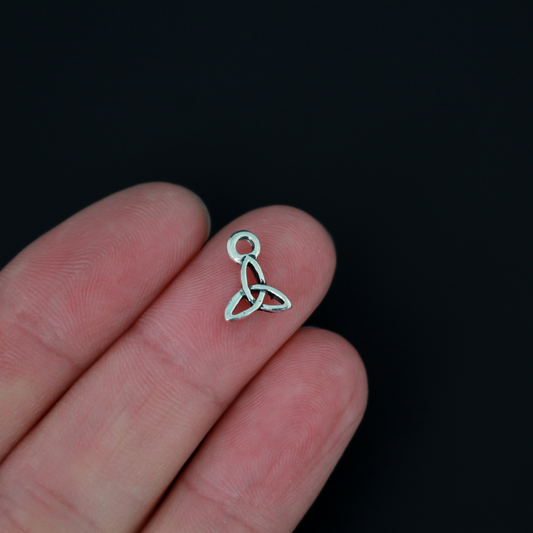 Celtic trinity knot charms that are an antiqued silver tone color. The trinity knot is a symbol of the the holy trinity