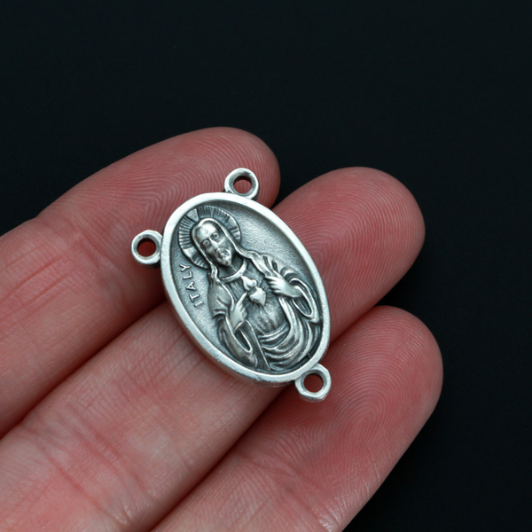 One inch oval rosary centerpiece that features an image of The Immaculate Heart of Mary on the front with an image of The Sacred Heart of Jesus on the back
