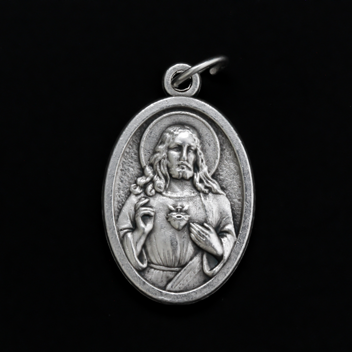 One inch oval medal that features an image of The Immaculate Heart of Mary on the front with an image of The Sacred Heart of Jesus on the back
