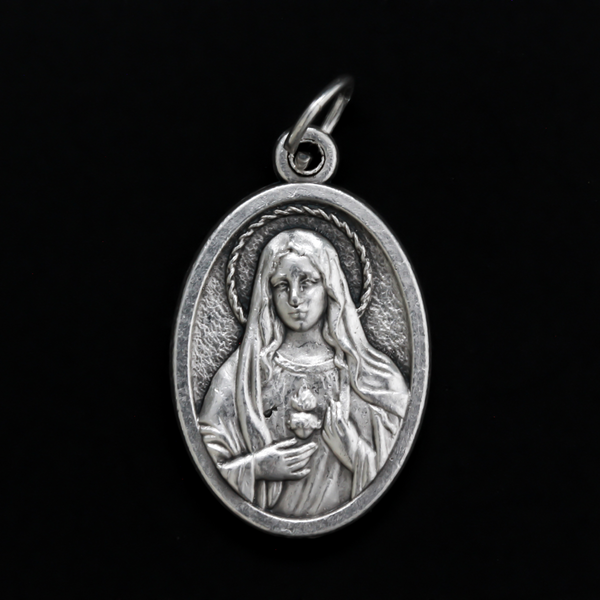 One inch oval medal that features an image of The Immaculate Heart of Mary on the front with an image of The Sacred Heart of Jesus on the back