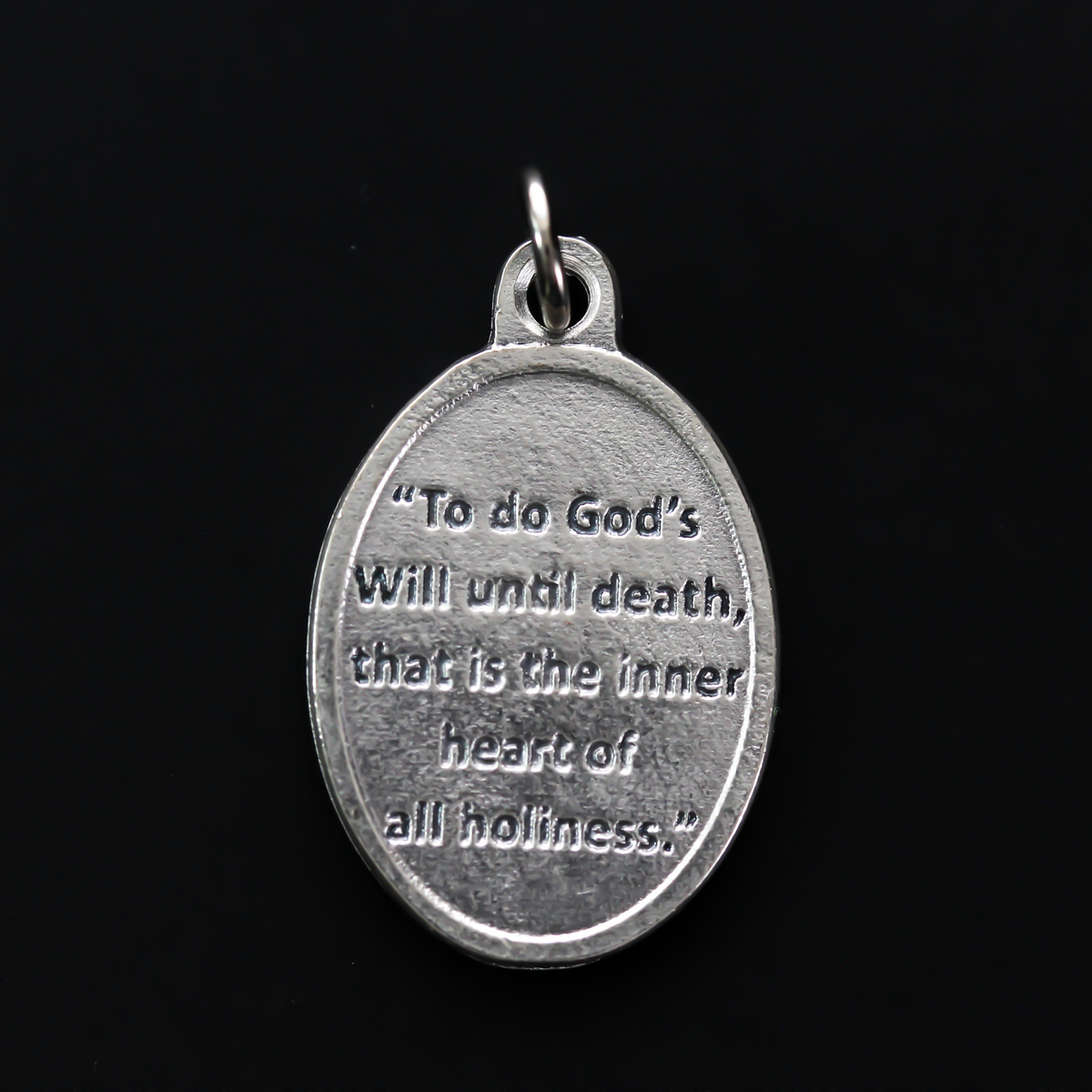 Archbishop Fulton Sheen medal that has one of his quotes on the backside "To do God's will until death, that is the inner heart of all holiness"