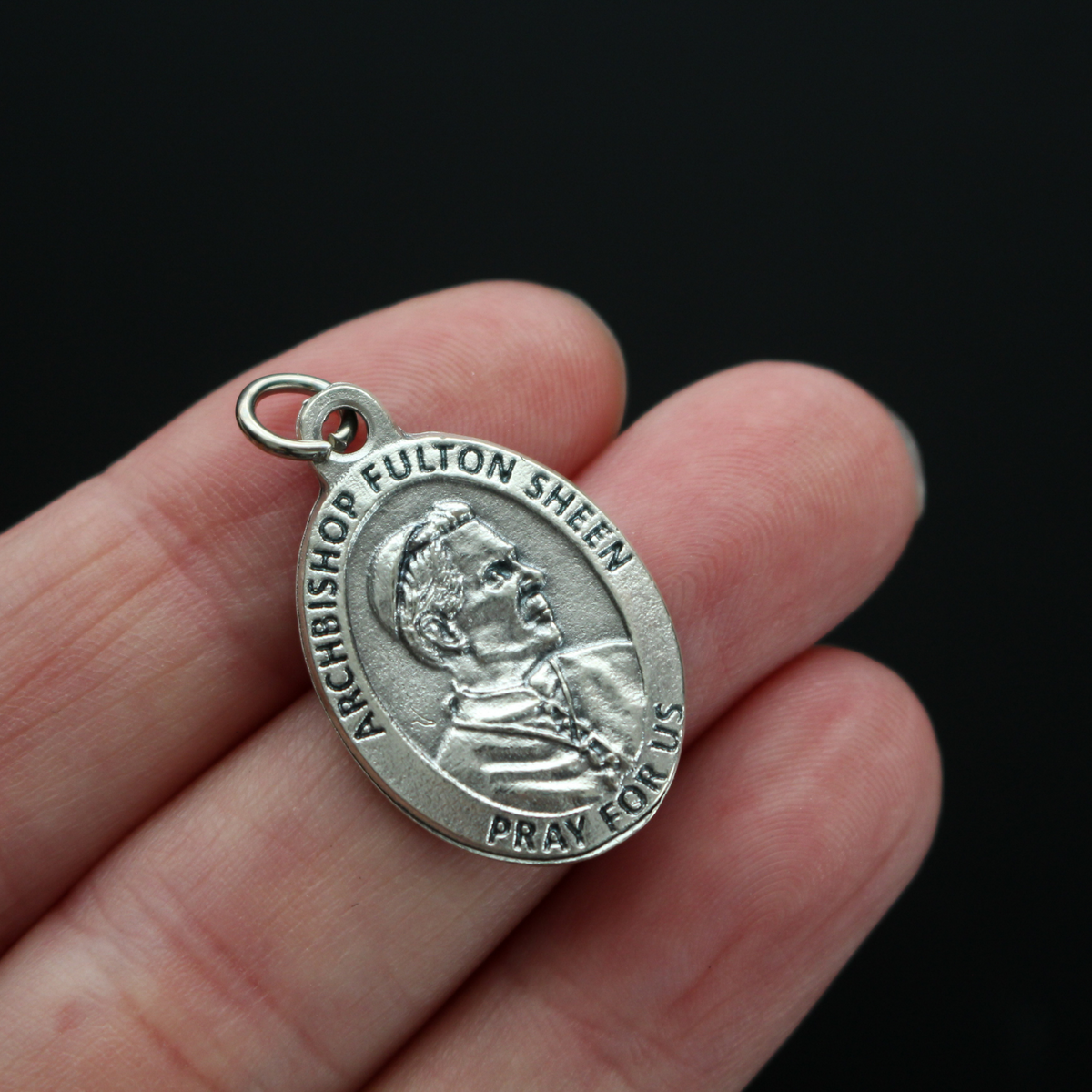 Archbishop Fulton Sheen medal that has one of his quotes on the backside "To do God's will until death, that is the inner heart of all holiness"