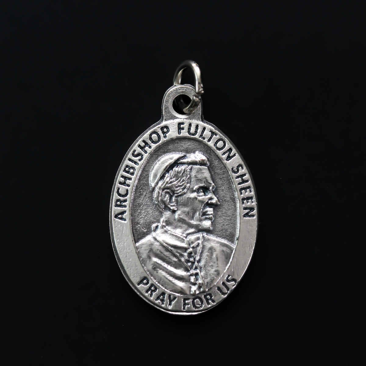 Archbishop Fulton Sheen medal that has one of his quotes on the backside "To do God's will until death, that is the inner heart of all holiness"