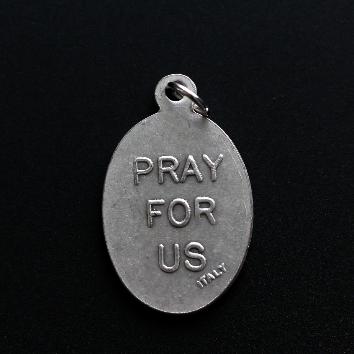 Saint Vincent De Paul oval religious medal. The front of the medal depicts the saint and the reverse is marked "Pray For Us