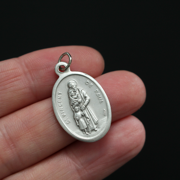 Saint Vincent De Paul oval religious medal. The front of the medal depicts the saint and the reverse is marked "Pray For Us
