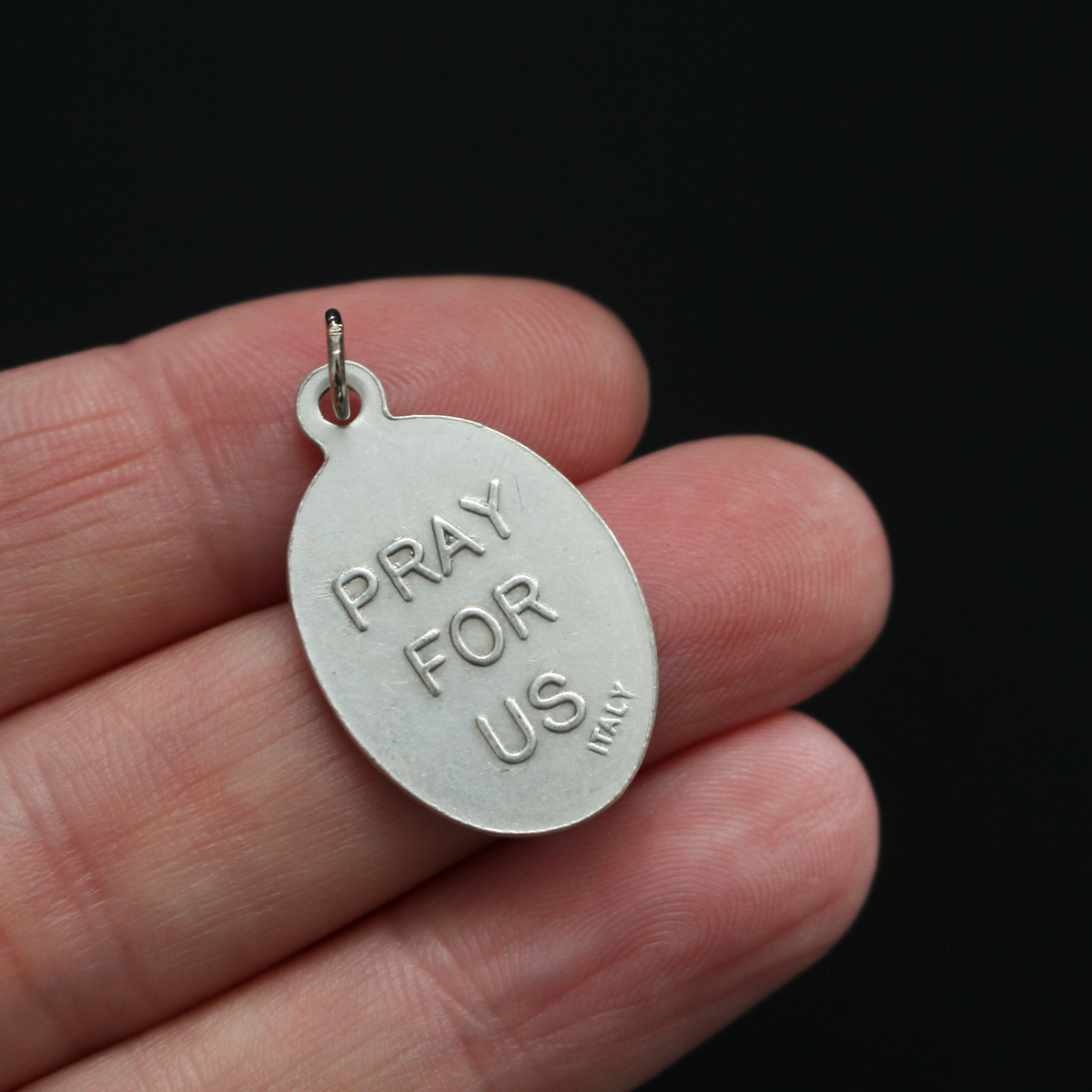 Saint Vincent De Paul oval religious medal. The front of the medal depicts the saint and the reverse is marked "Pray For Us