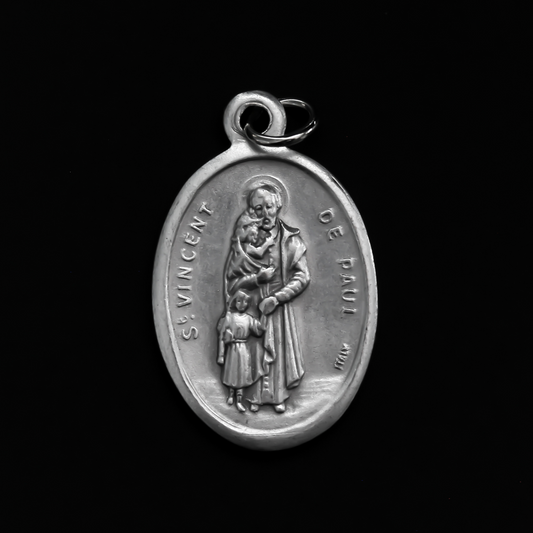 Saint Vincent De Paul oval religious medal. The front of the medal depicts the saint and the reverse is marked "Pray For Us
