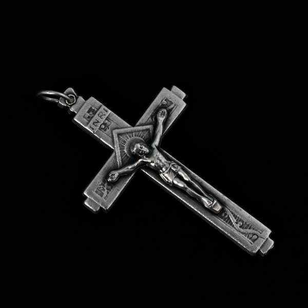 This detailed crucifix was made in Italy and has a sunburst nimbus detail behind the head of Jesus. 