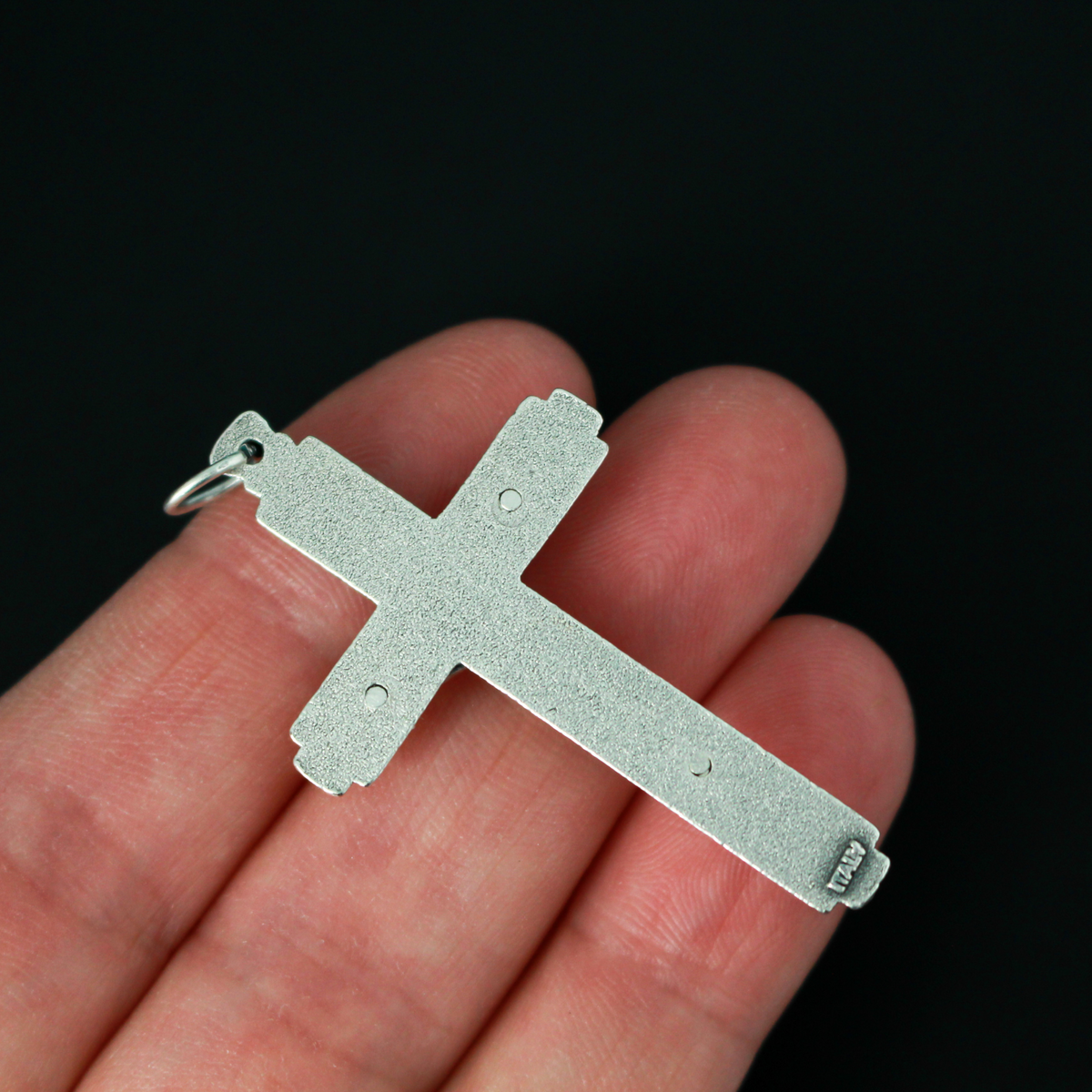 This detailed crucifix was made in Italy and has a sunburst nimbus detail behind the head of Jesus. 