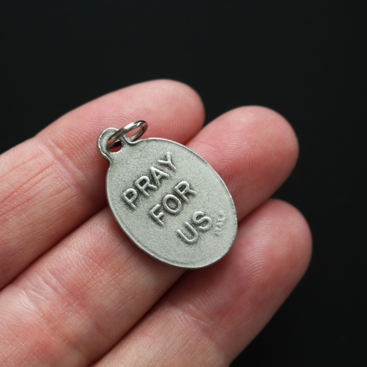 Virgin of Mercy medal that depicts Our Lady on the front and is marked "Pray For Us" on the back