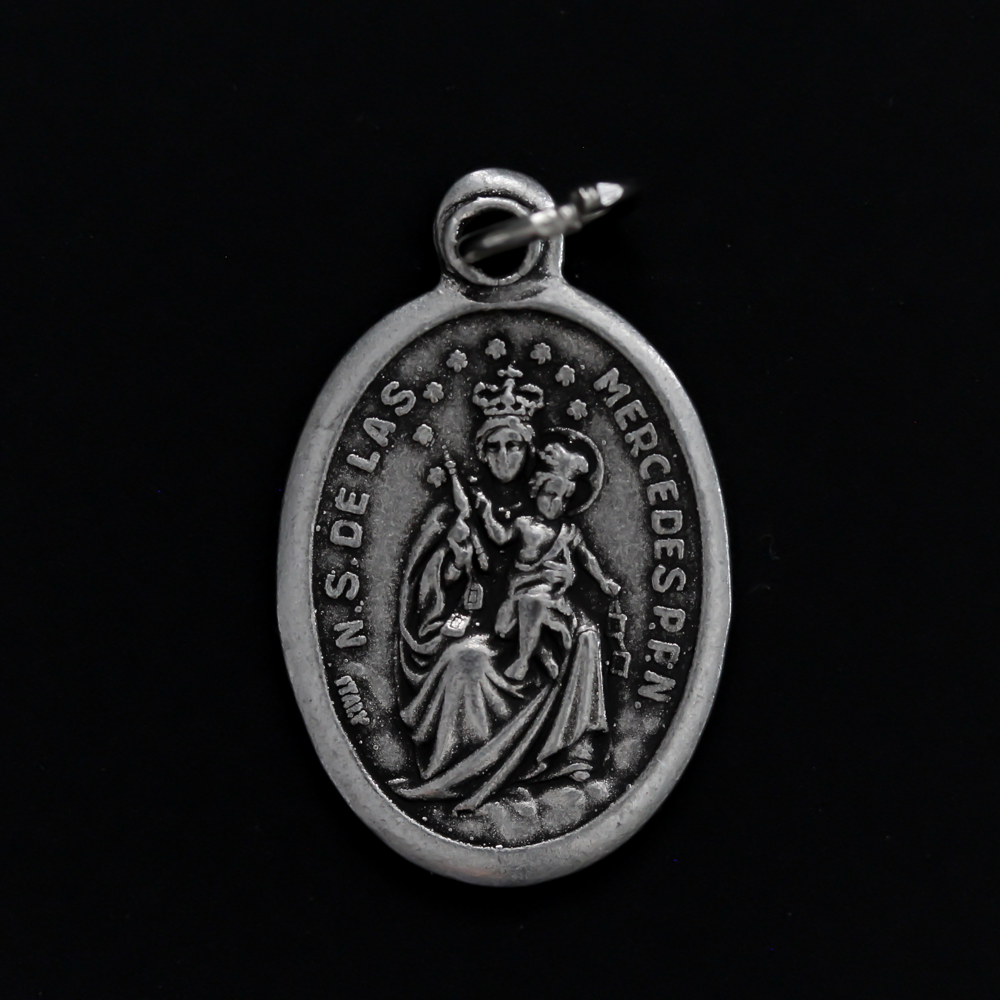 Virgin of Mercy medal that depicts Our Lady on the front and is marked "Pray For Us" on the back