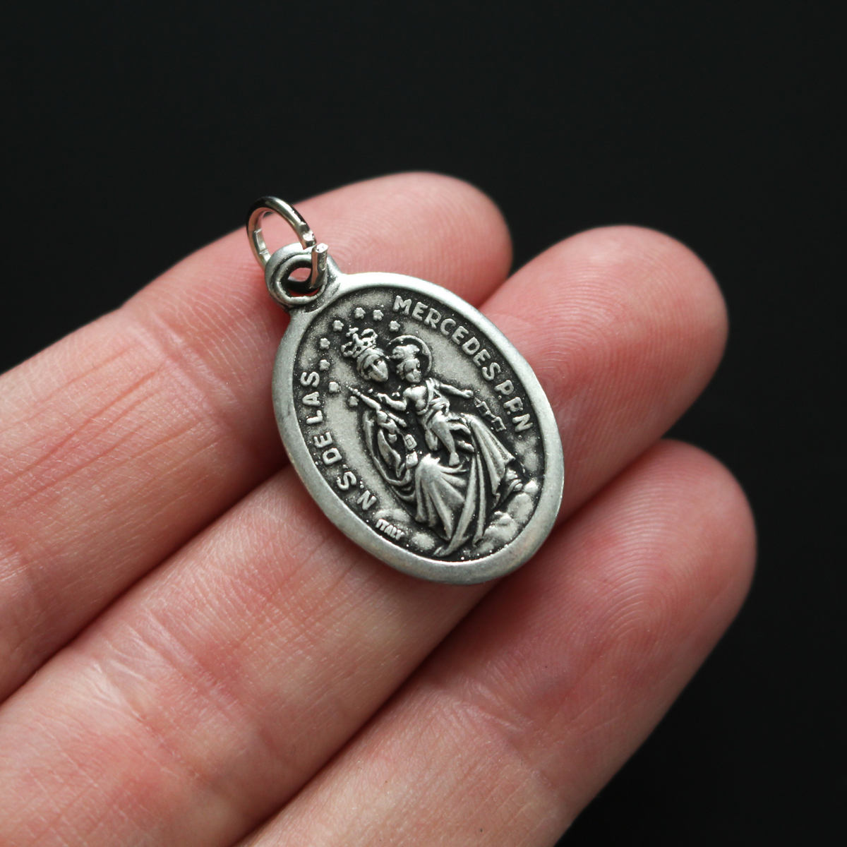Virgin of Mercy medal that depicts Our Lady on the front and is marked "Pray For Us" on the back